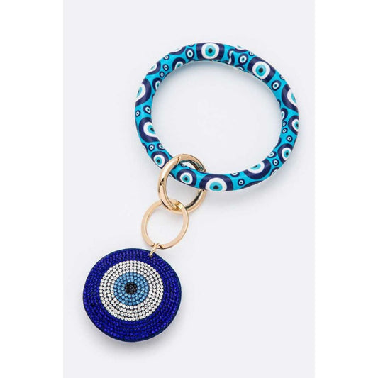 Keychain with blue and white patterned band and round blue evil eye charm on a white background