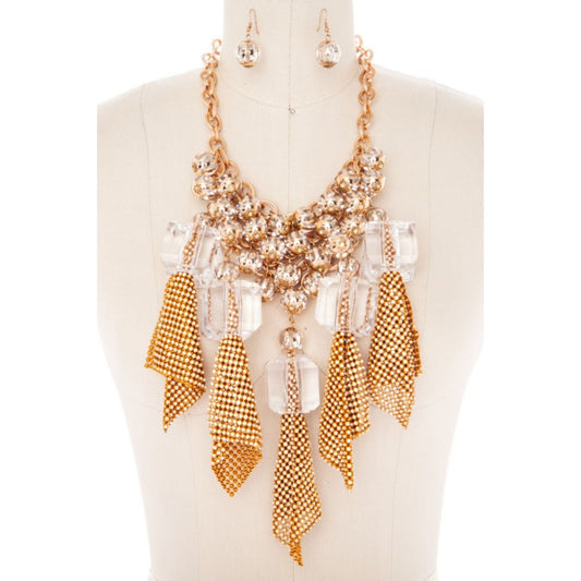 Gold and clear beaded necklace with matching earrings on a mannequin.