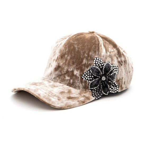 Brown distressed baseball cap with a decorative black flower on a white background