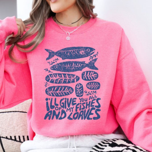 Person wearing a pink sweatshirt with blue fish and text design.