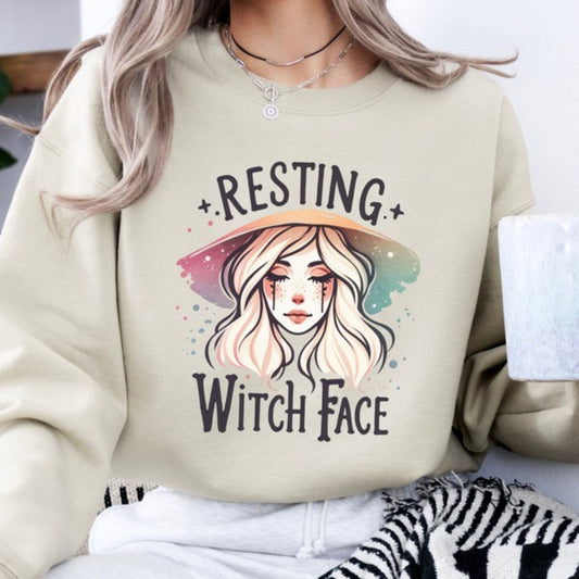 Sand sweatshirt with 'Resting Witch Face' design and a person wearing it.