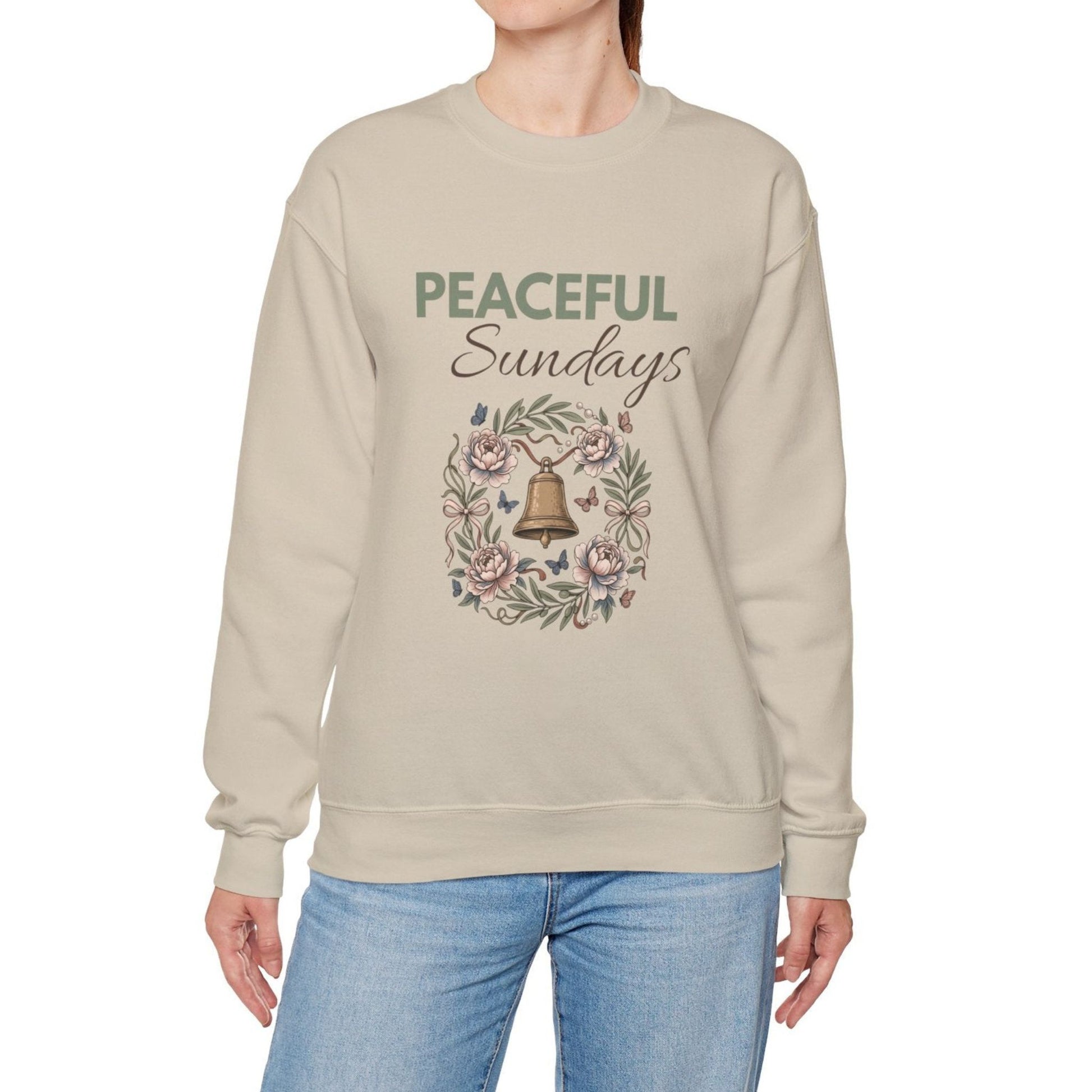 A woman is wearing a Sand-colored sweatshirt with 'PEACEFUL Sundays' on the front.