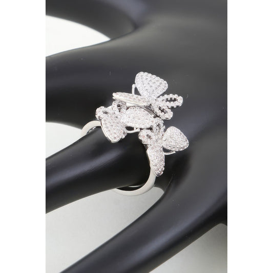 Silver butterfly-shaped ring on a black and white background