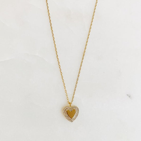Gold heart-shaped necklace on a white background