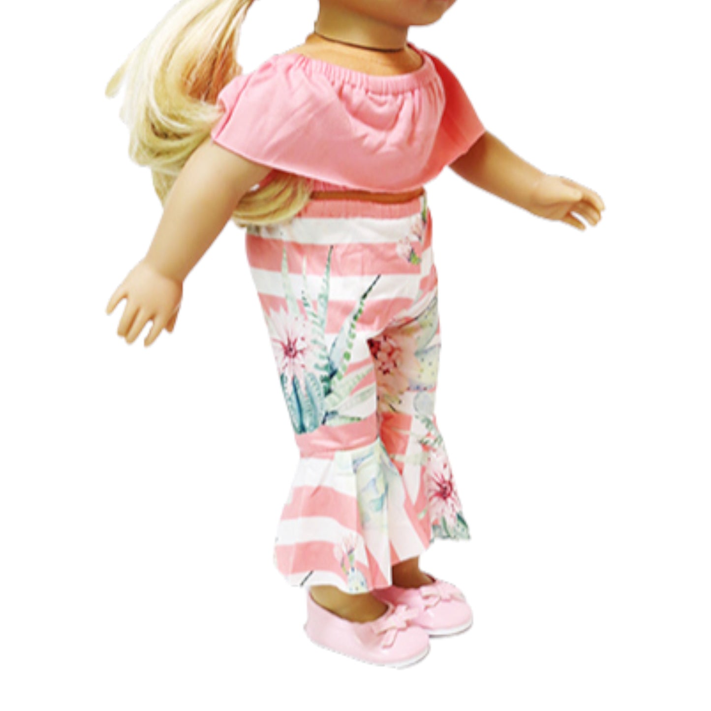 Doll wearing a pink top and floral pants on a white background