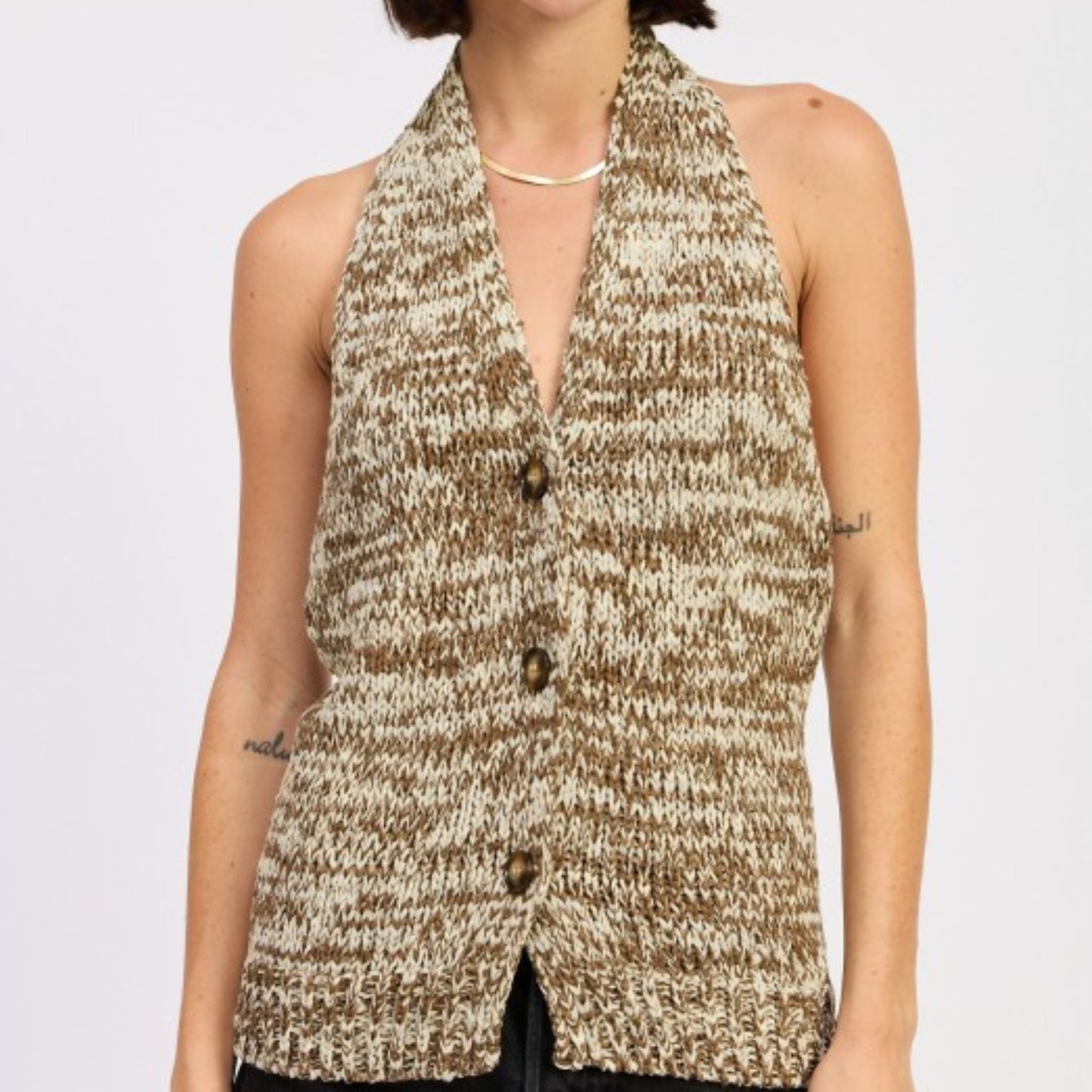 Model wearing a taupe brown halter neck button front top.