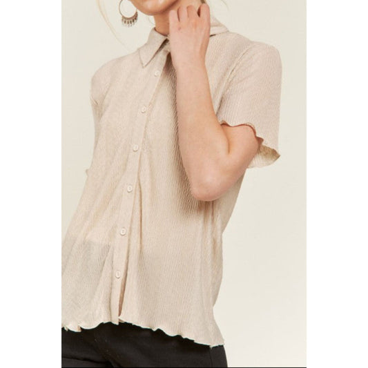 Beige sleeveless button-up shirt worn by a person on a white background