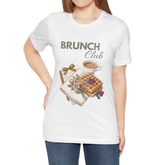 A woman is wearing a white t-shirt with 'BRUNCH Club' on the front.