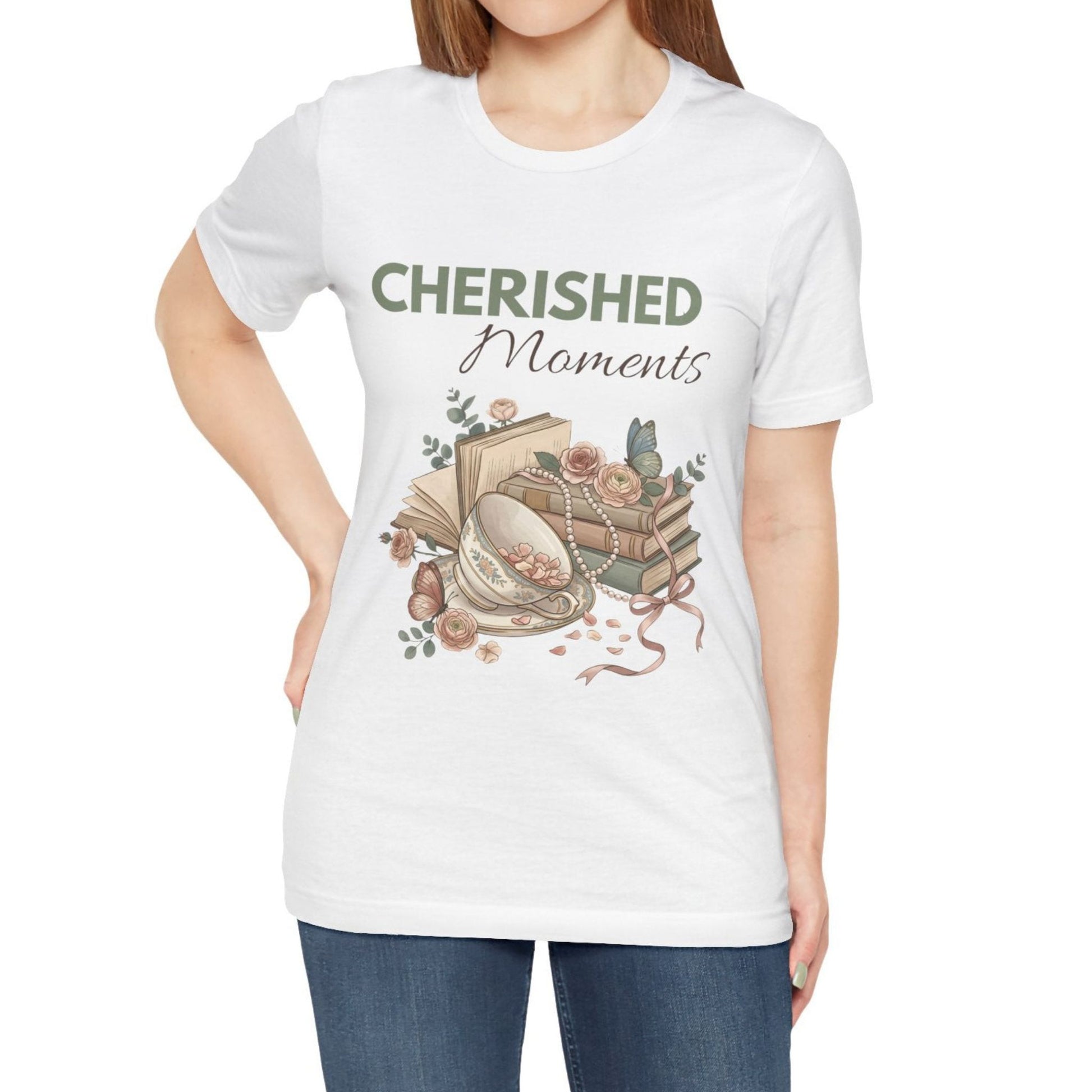 A woman is wearing a white t-shirt with 'CHERISHED Moments' on the front.