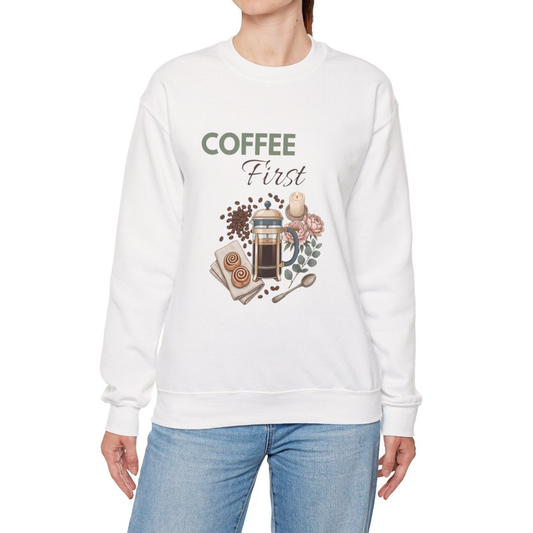 A woman is wearing a white sweatshirt with 'COFFEE First' on the front.