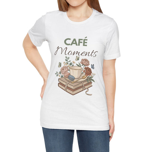 White t-shirt with 'Café Moments' design featuring a coffee cup and books on a white background