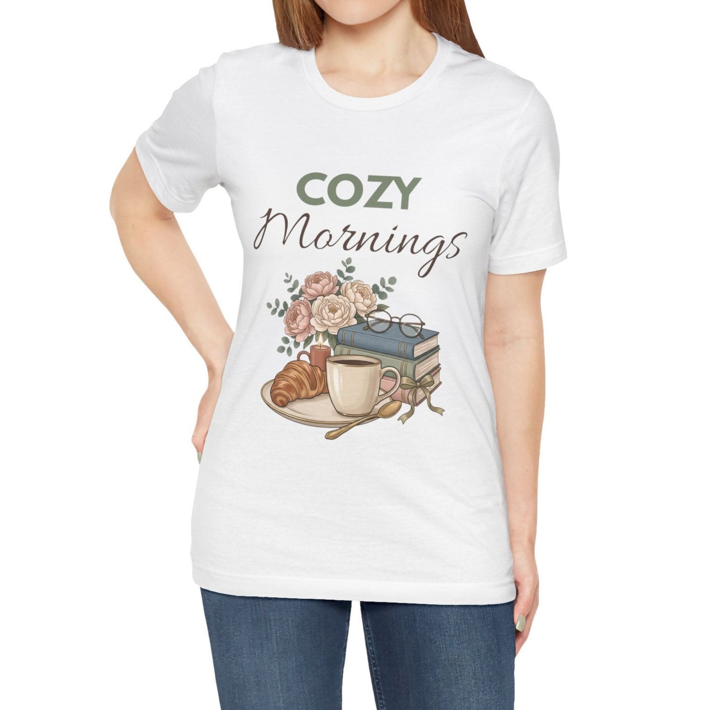 White t-shirt with 'Cozy Mornings' graphic design featuring a coffee cup, croissant, and books.