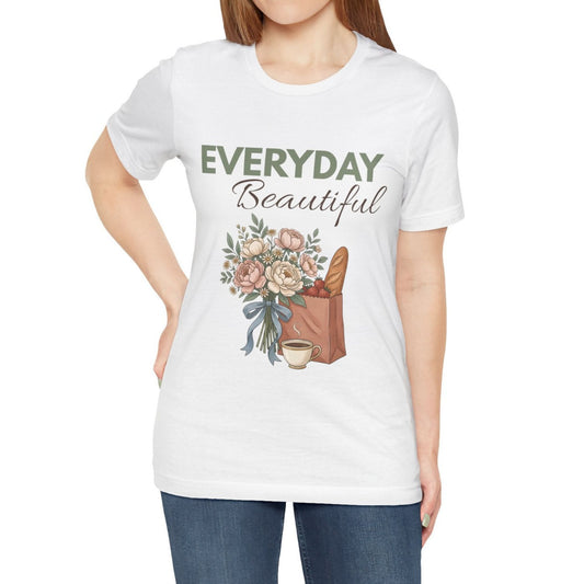 A woman wearing a white t-shirt with 'EVERYDAY Beautiful' on the front.