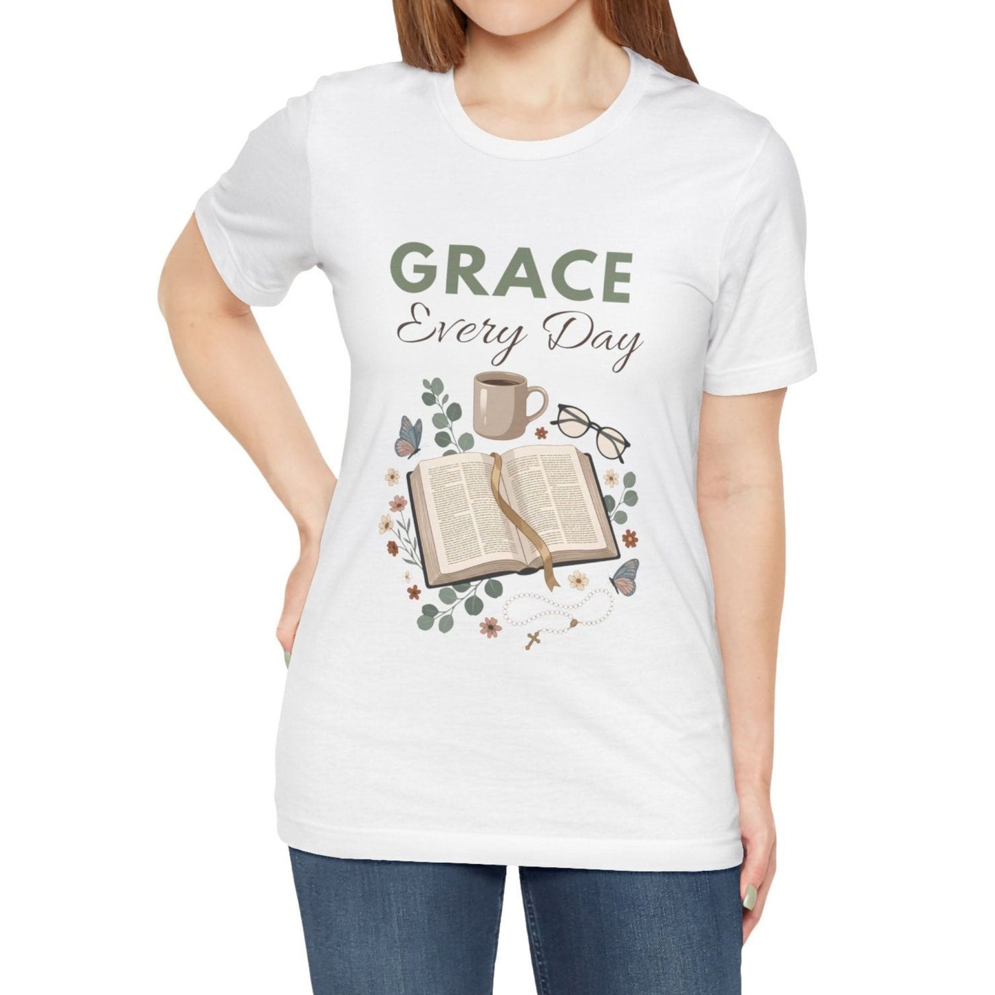 White t-shirt with 'Grace Every Day' design featuring a book, coffee cup, and glasses on a white background.