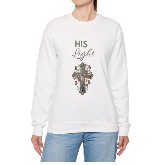 A woman is wearing a white sweatshirt with 'His Light' on the front.