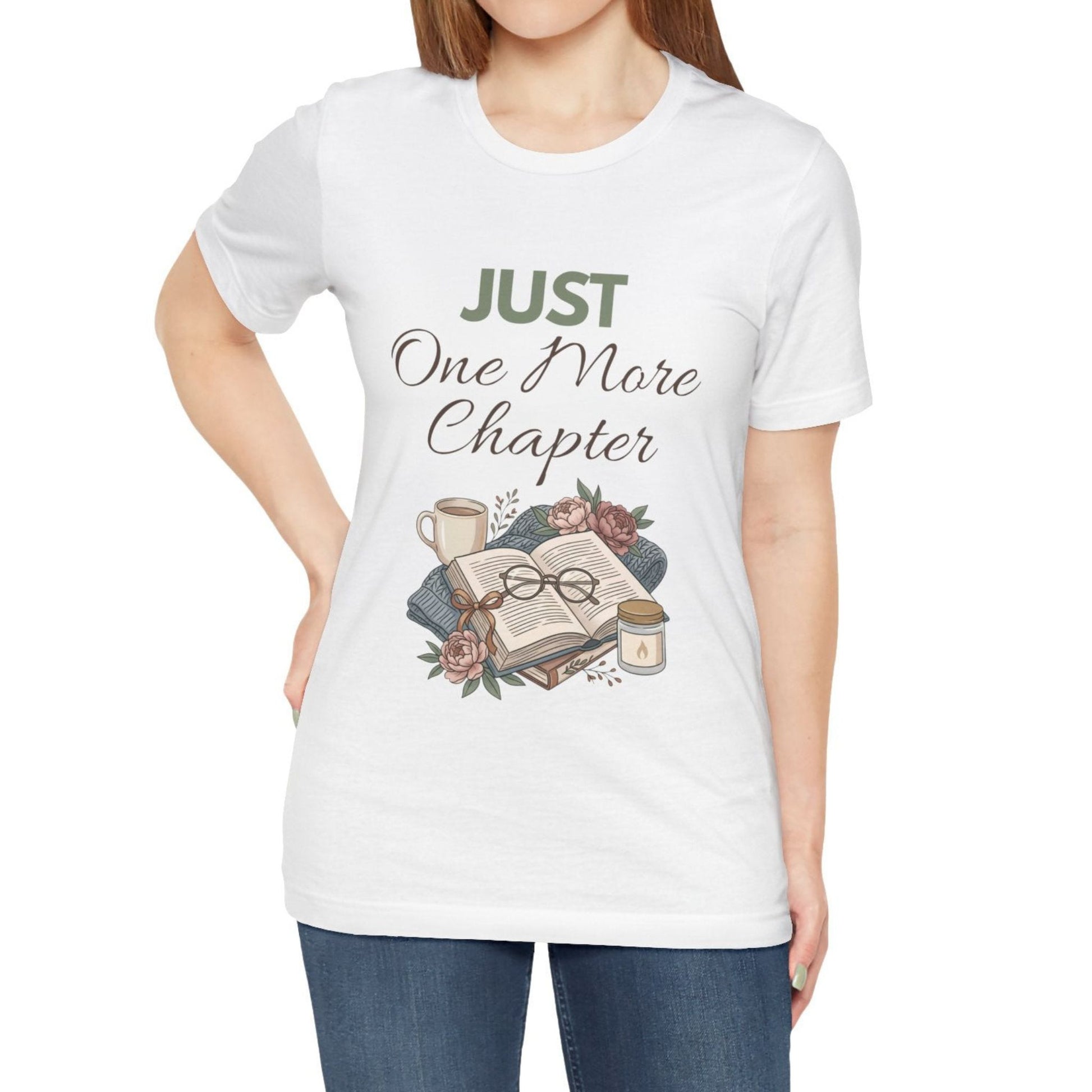 Person wearing a white t-shirt with 'Just One More Chapter' design on a plain background