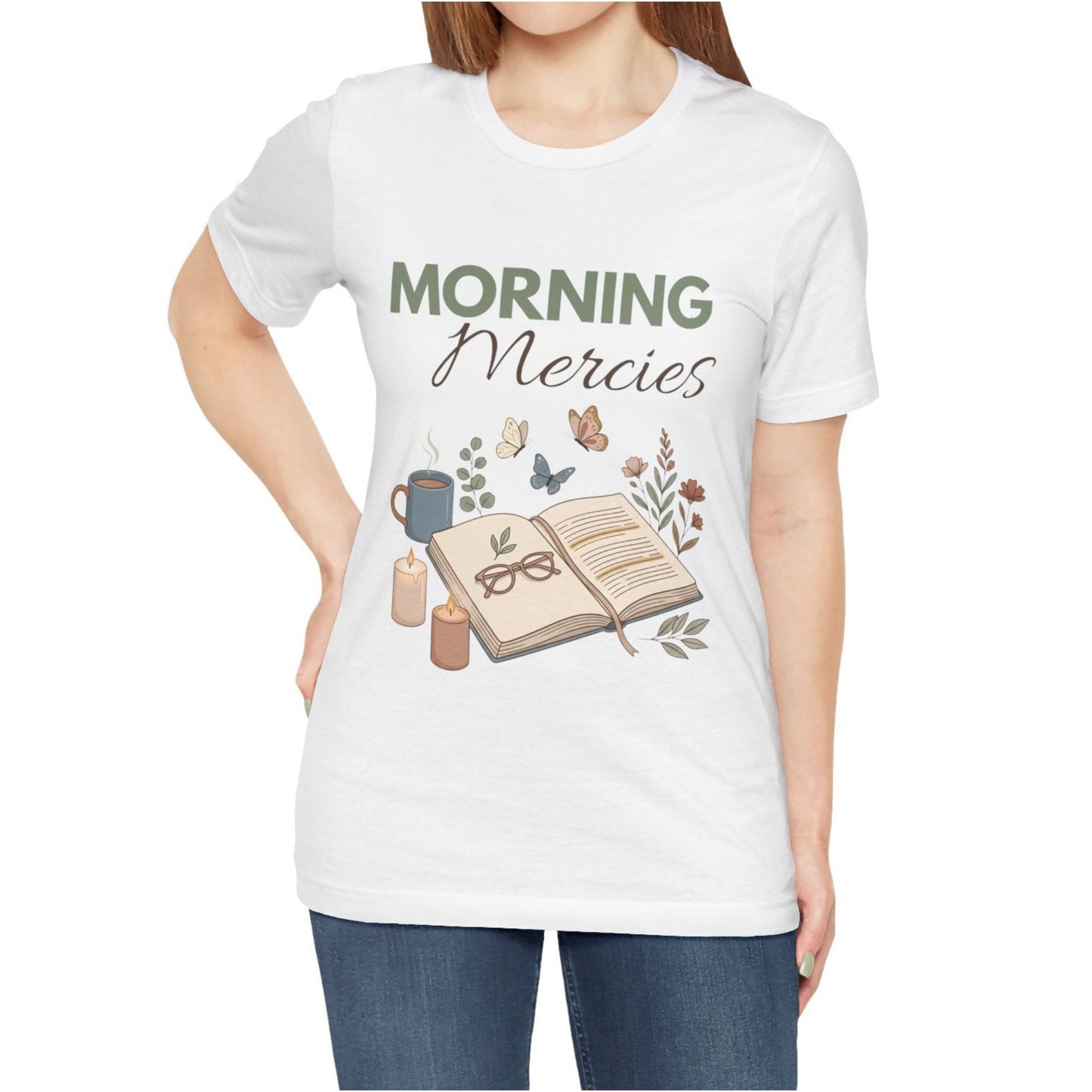 White t-shirt with 'Morning Mercies' design featuring a book, coffee cup, and candles on a white background.