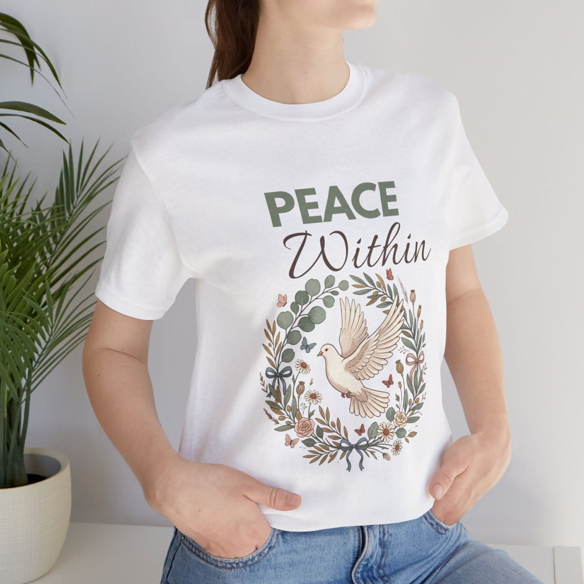 Person wearing a white t-shirt with 'Peace Within' design and text.