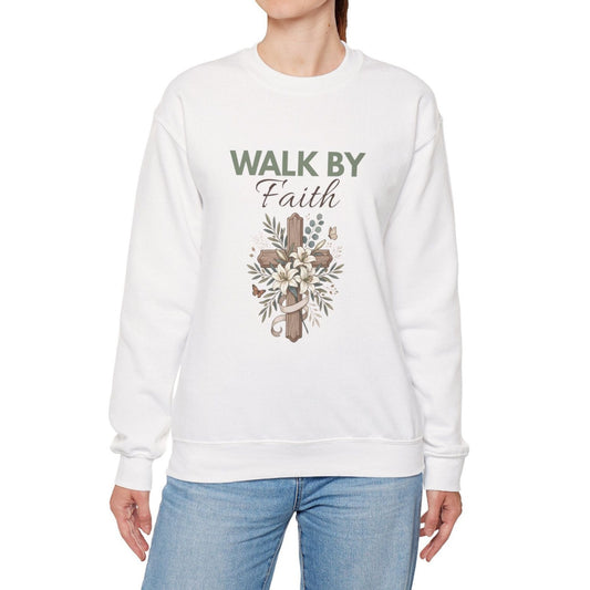 A woman wearing a white crewneck sweatshirt with 'WALK BY Faith' on the front.