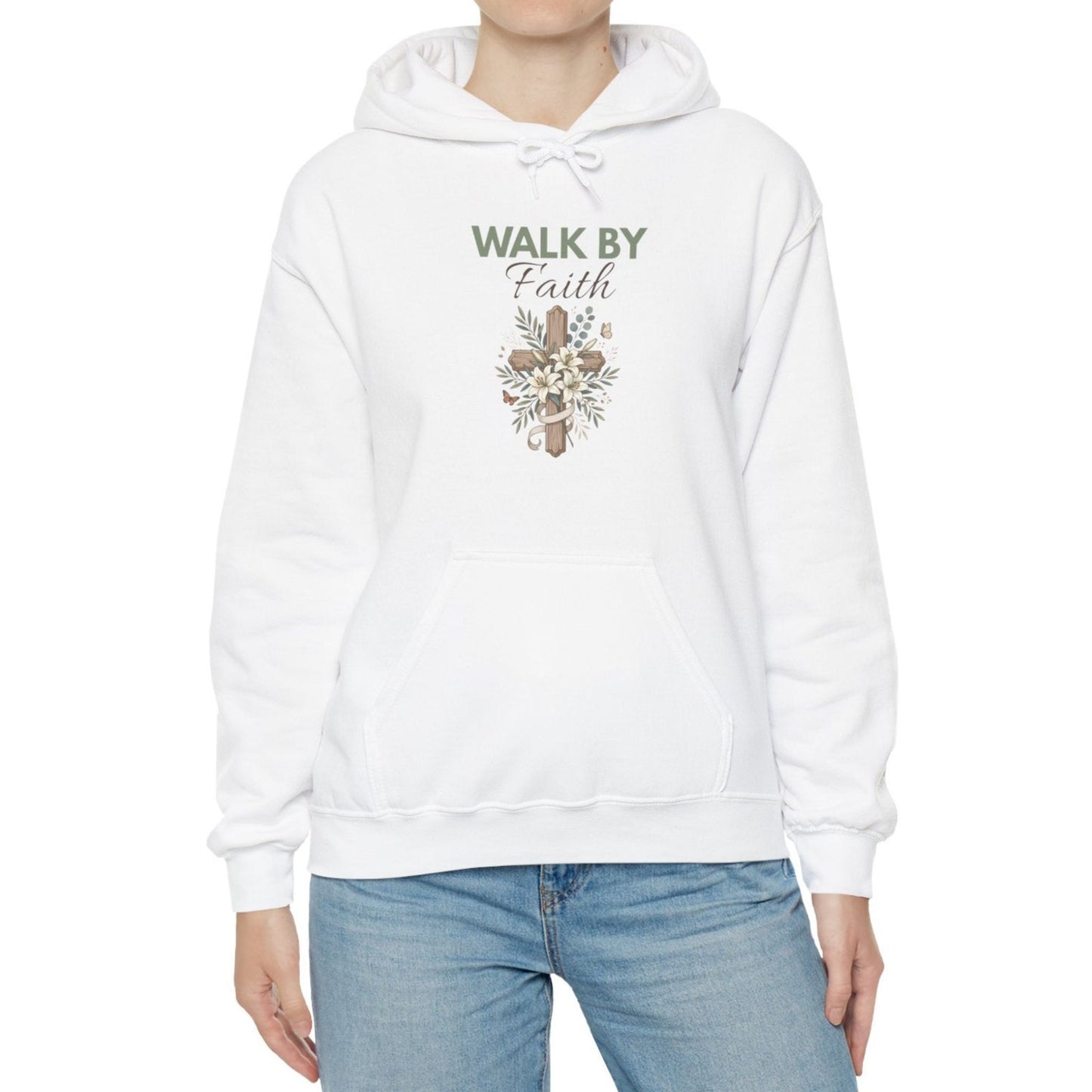 A woman is wearing a white hooded sweatshirt with  'WALK BY Faith' on the front.