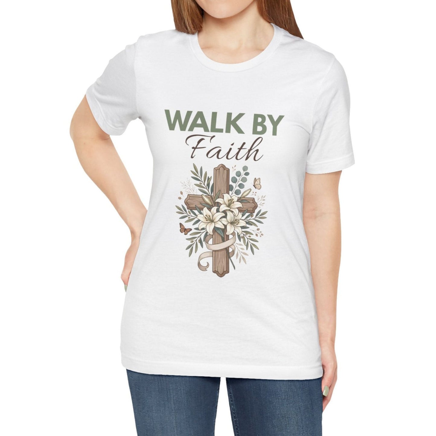 White t-shirt with 'Walk by Faith' text and cross design worn by a person on a white background