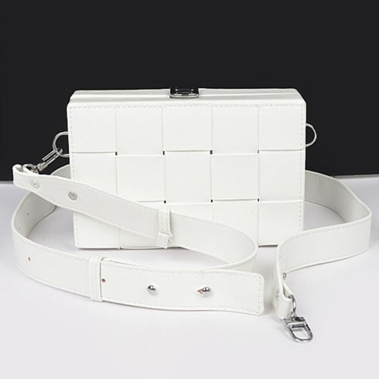 White quilted handbag with a strap on a white background