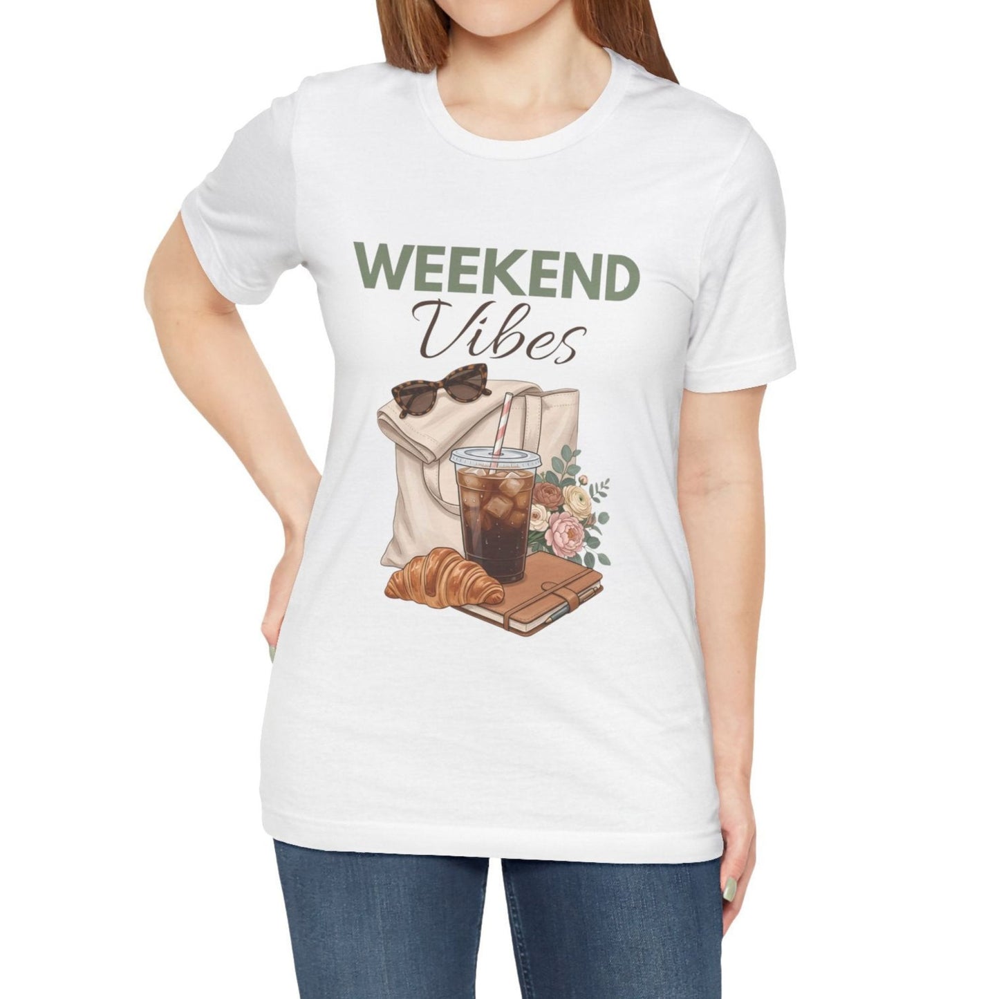 White t-shirt with 'Weekend Vibes' graphic design featuring a coffee cup, croissant, and sunglasses on a white background.