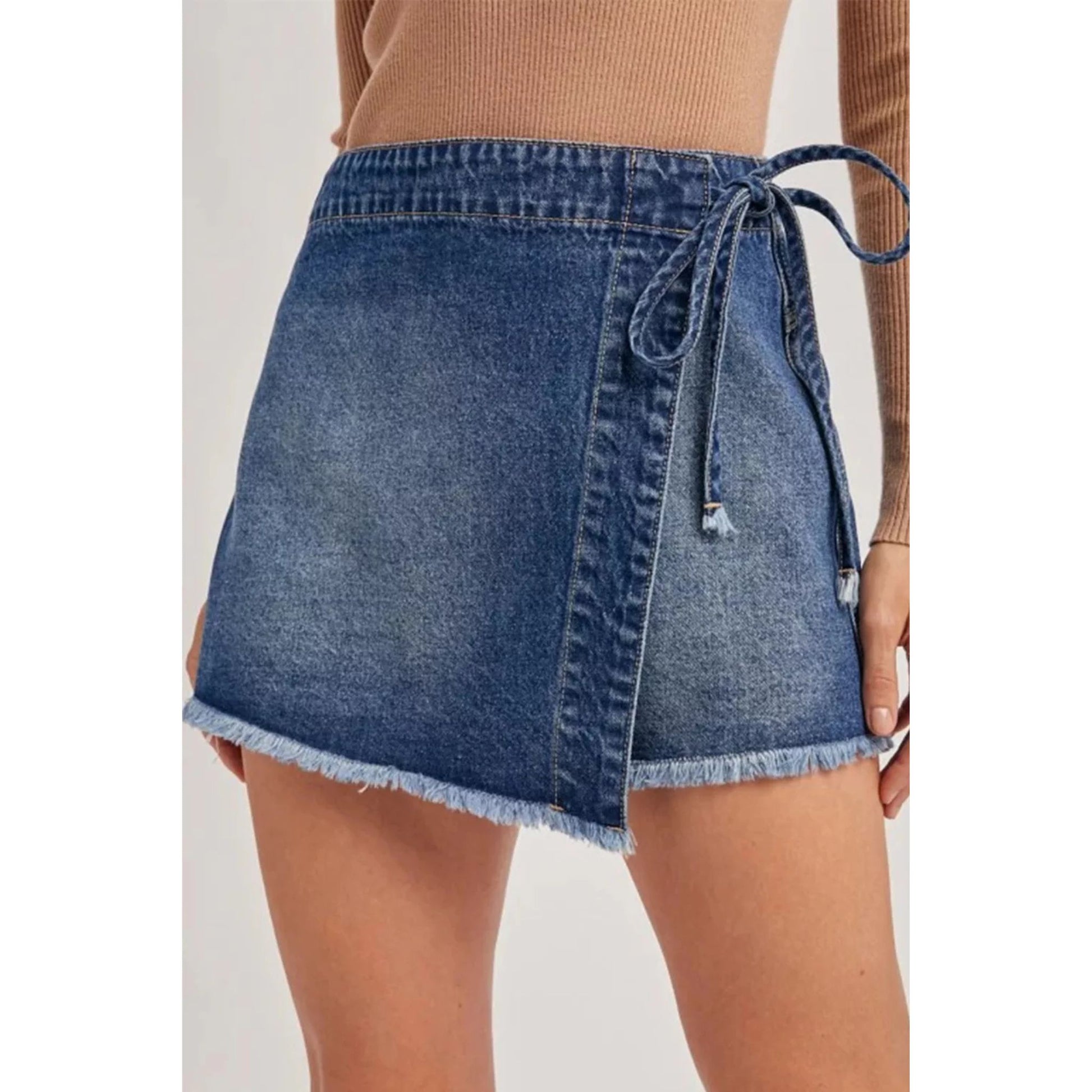Denim skirt with a tie waist on a plain background
