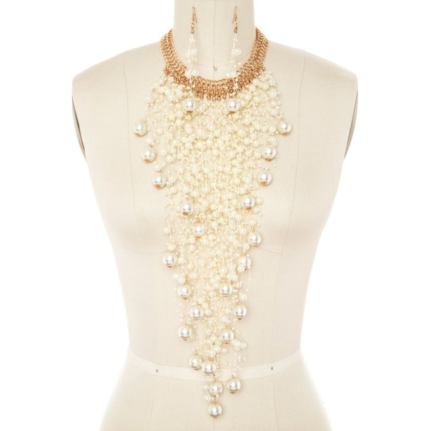 Mannequin wearing a long pearl necklace on a white background