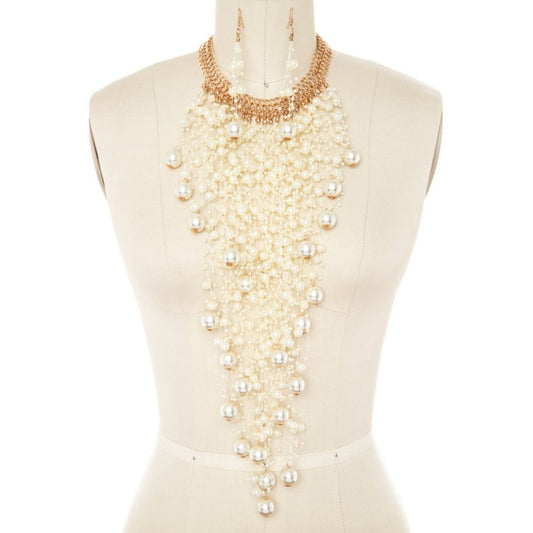Mannequin wearing a long pearl necklace on a white background